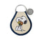 tan patch keychain with snoopy holding a bouquet of flowers and navy blue trim