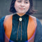 model wearing teal and orange poppy bolo tie with brown cord and gold tips