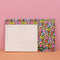 front and back of dark green desk pad with colorful floral print