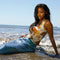 model wearing white tank with colorful seashell print and blue trim