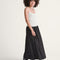 model wearing black skirt with white polka dot print