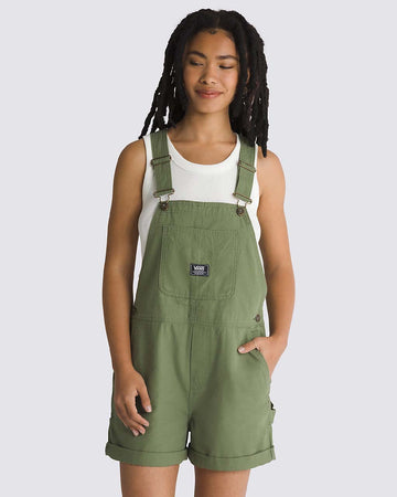 model wearing green shortall with front pocket and vans patch