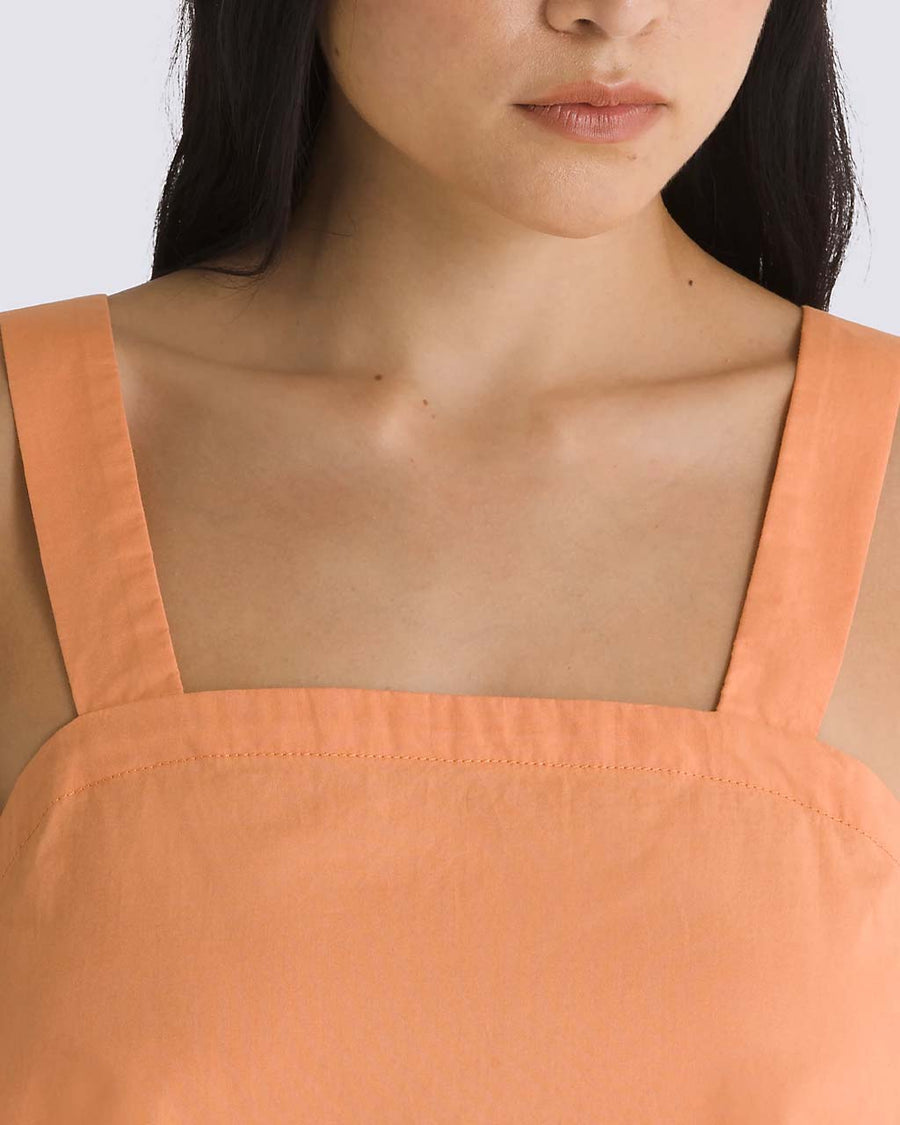 up close of model wearing peach cropped tank with square neckline