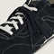 up close of black vans super low pro trainer sneakers with white laces