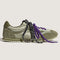 side view of dark green and metallic sage super low pro sneakers with black and white speckled laces and purple laces