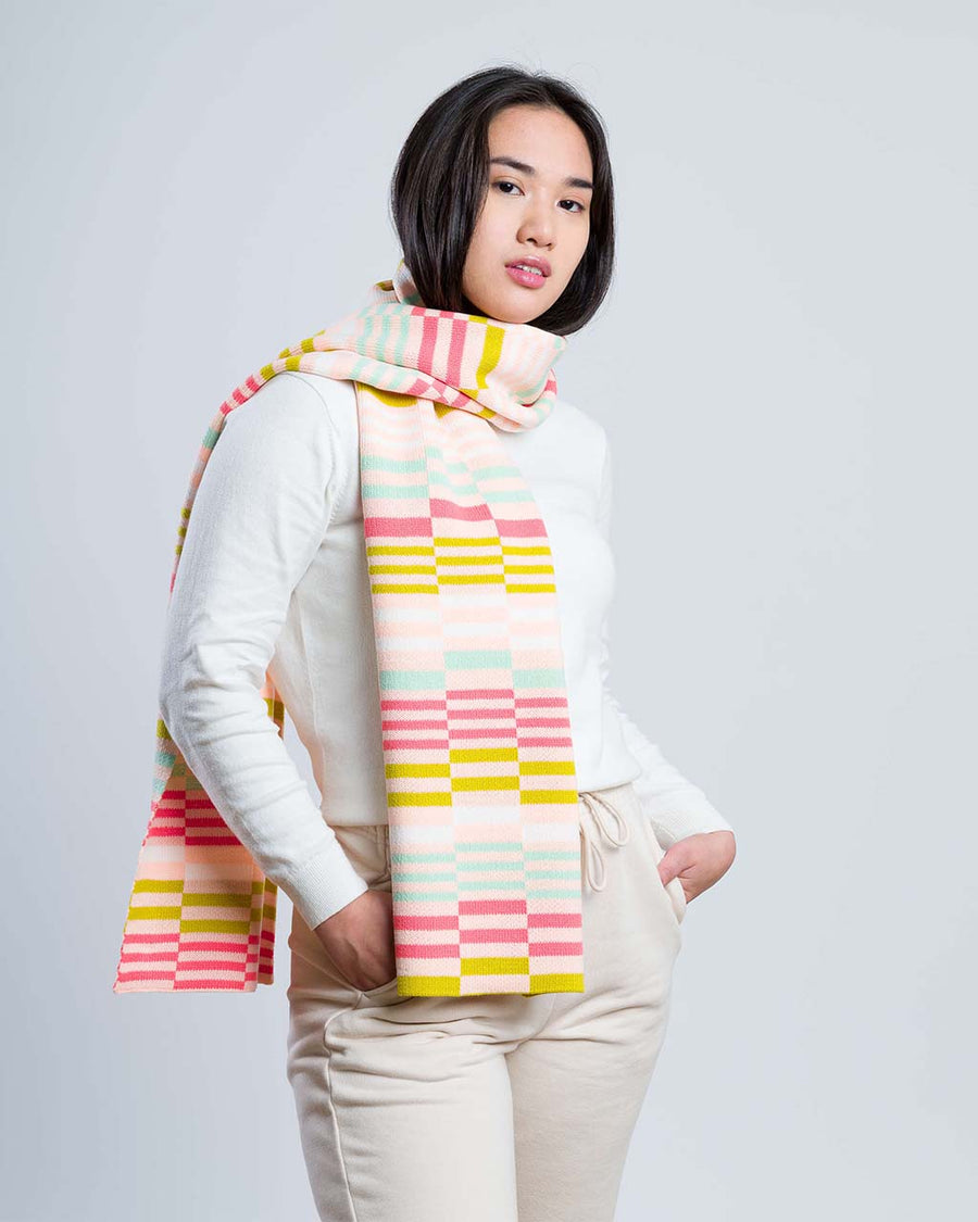 model wearing checkerboard scarf in pink, green, white and blue tones