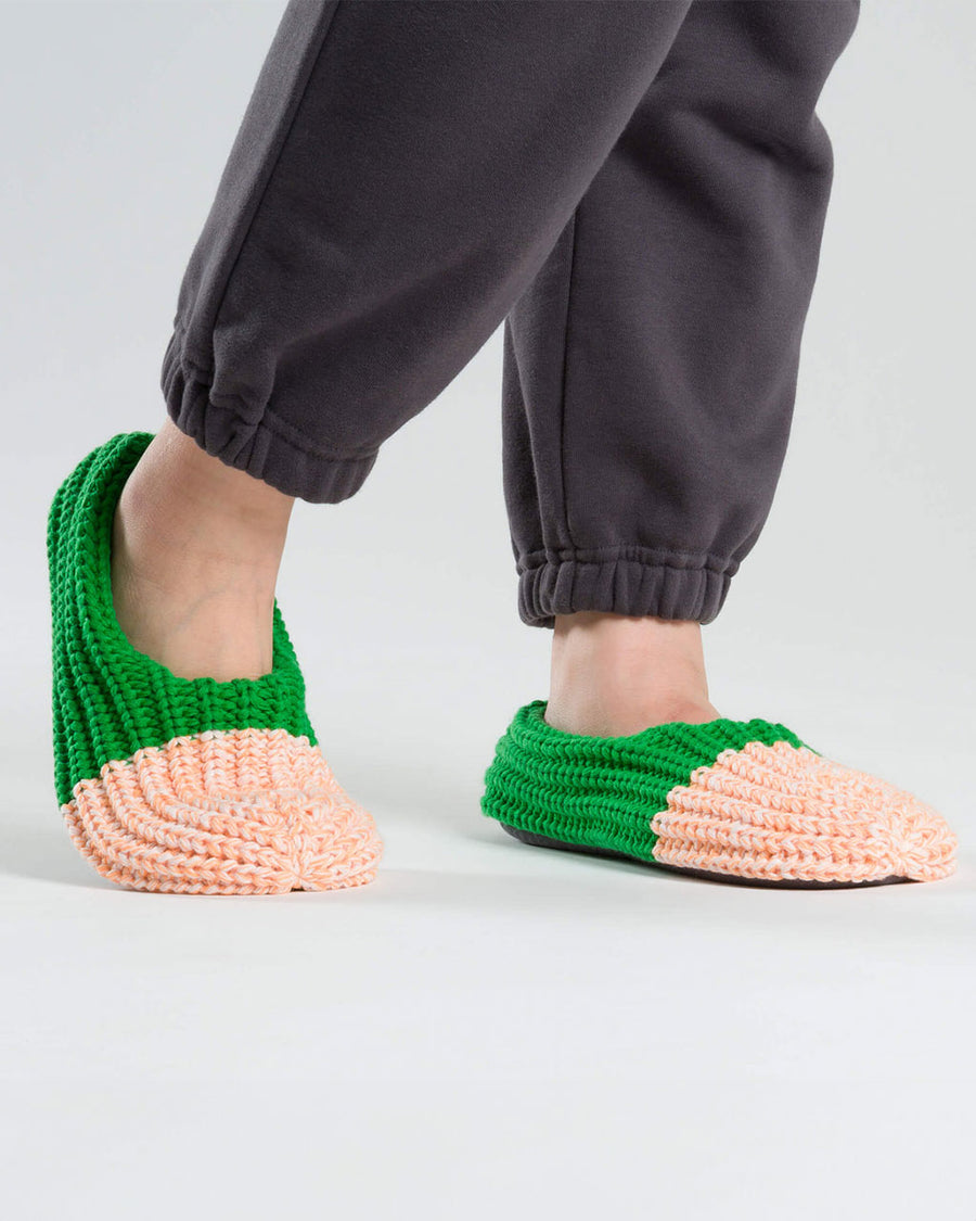 model wearing split pink and green ribbed slippers