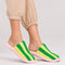 model wearing lime green multi striped slide slippers with pink and white sole