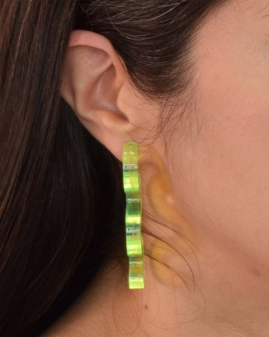 side view of green acrylic squiggle earrings