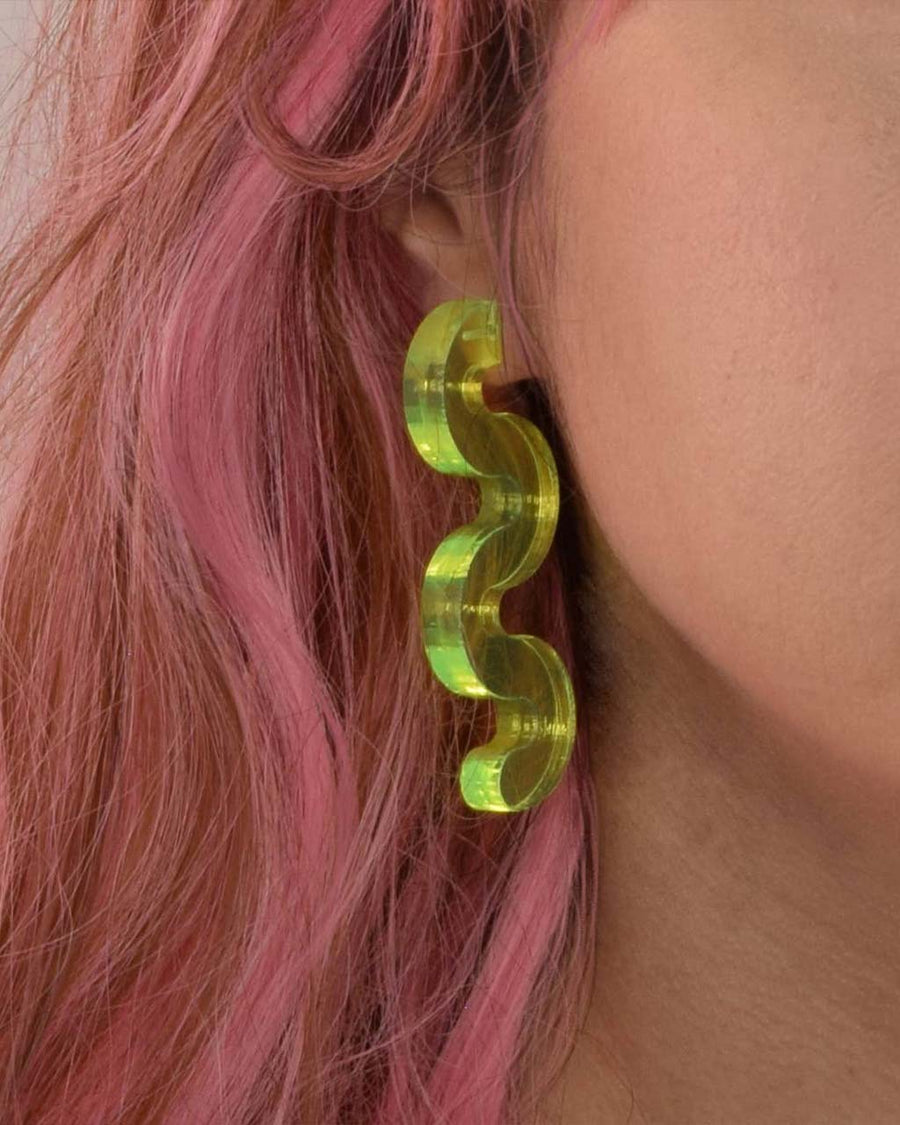 model wearing green acrylic squiggle earrings