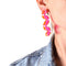 side view of pink acrylic squiggle earrings