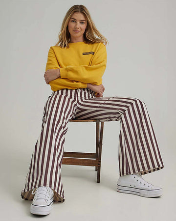 model wearing brown/purple and white vertical stripe flared jeans