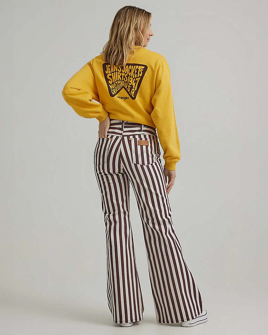 back view of model wearing brown/purple and white vertical stripe flared jeans