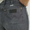 up close of black wrangler patch on back pocket