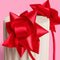up close of two red bows on the side of a headband