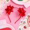 two red bows on the side of a headband