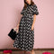 model wearing black midi dress with all over dove print, button front and collar detail