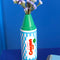 green crayon shaped flower vase with flowers inside