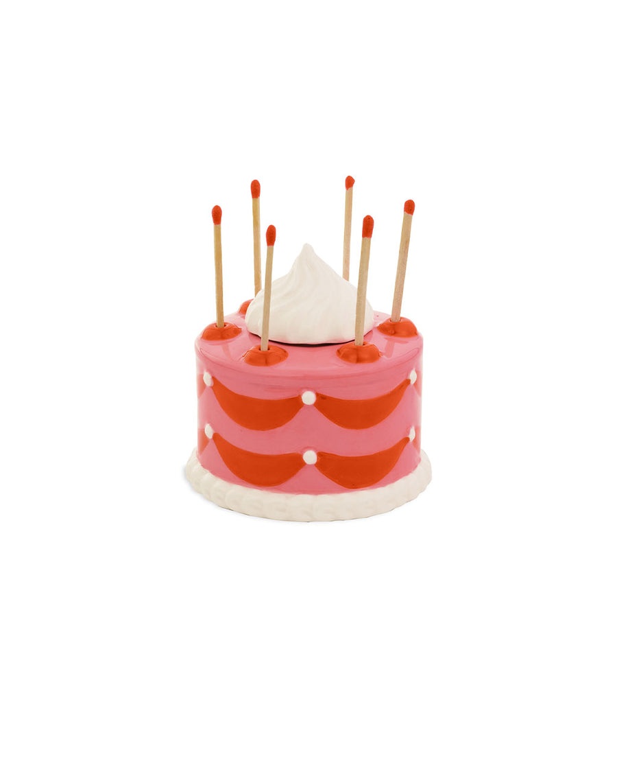 pink and red cake shaped match holder with matches inside