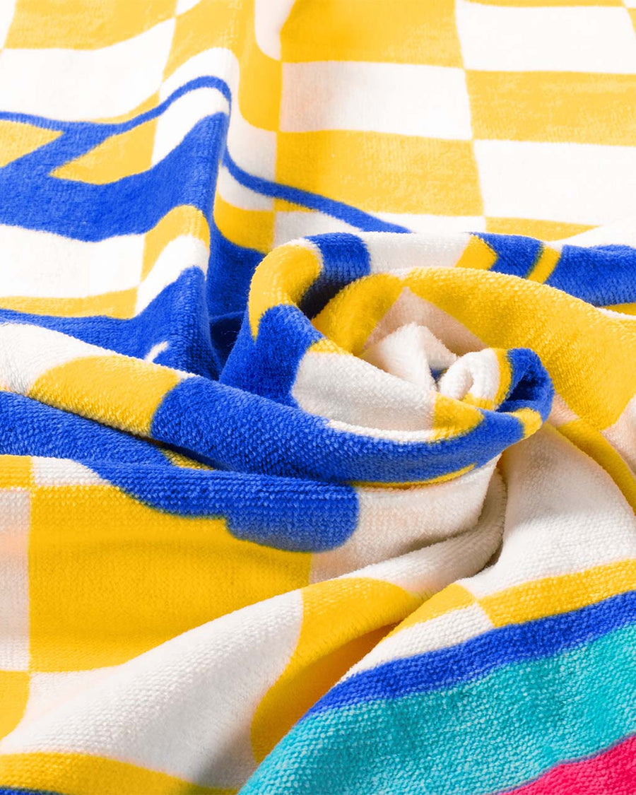 up close of colorful oversized towel with 'i survived the emotional rollercoaster at the feel it all carnival' with graphic on the front