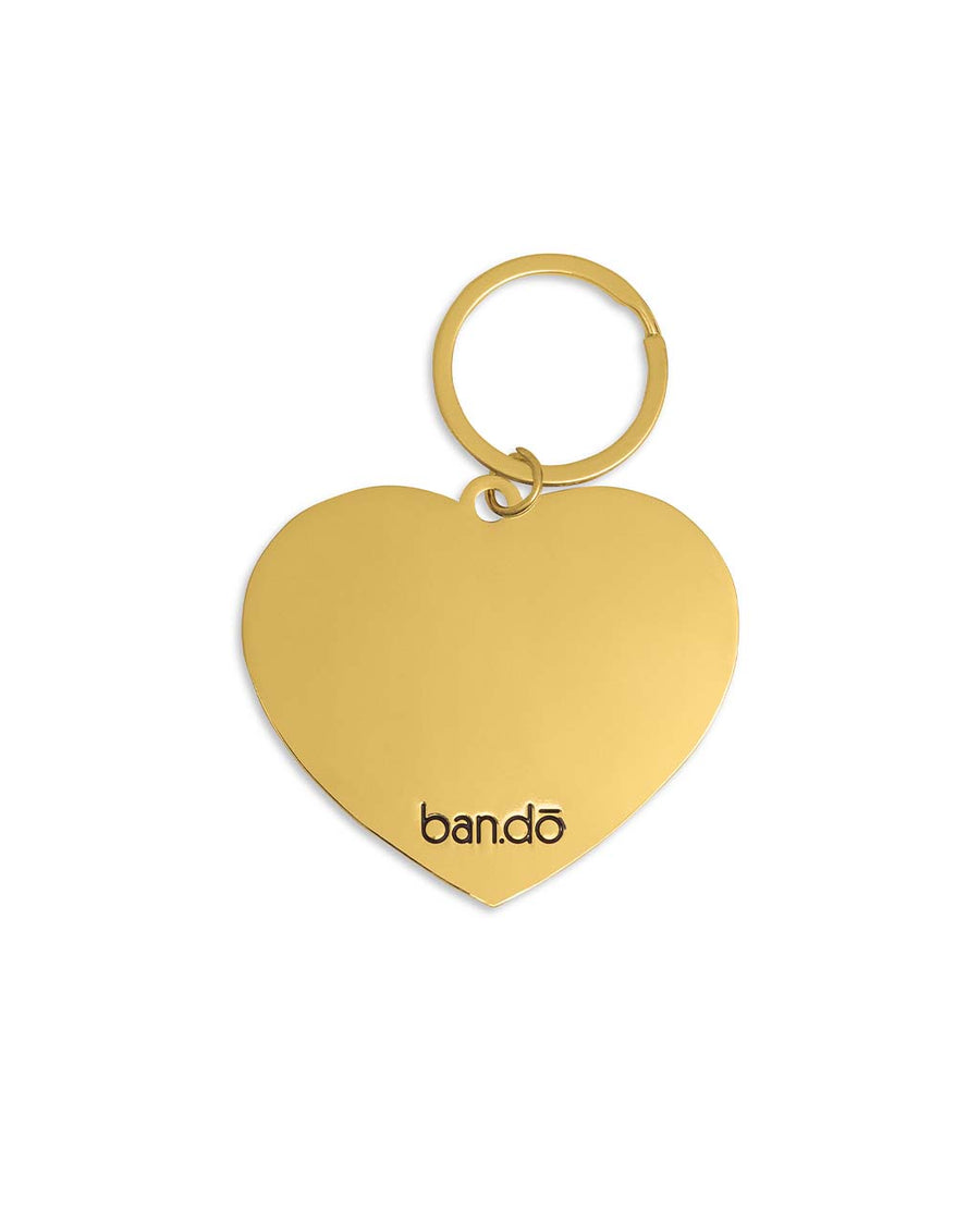 gold back of enamel heart shaped keychain that says 'i got smooched at the tunnel of love'