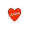 red heart shaped de-stress ball with white scalloped trim and white 'je t'aime!' across the front 