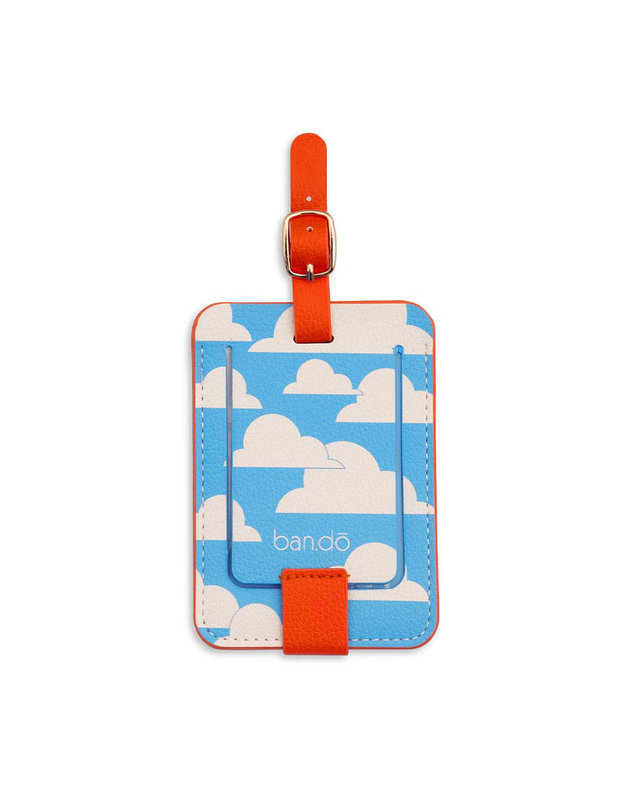 blue skies and clouds on the back of cream luggage tag with red trim and retro 'i'd rather be flying' across the front