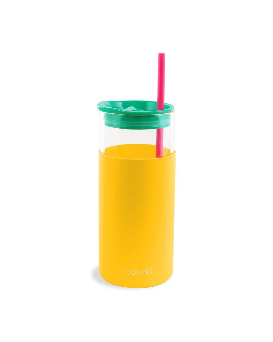 back view of glass tumbler with yellow sleeve that says 'i got smooched at the tunnel of love', green lid and pink straw