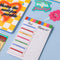 colorful stripe meal and shopping list notepad with magnetic back on table with notebook adn stickers