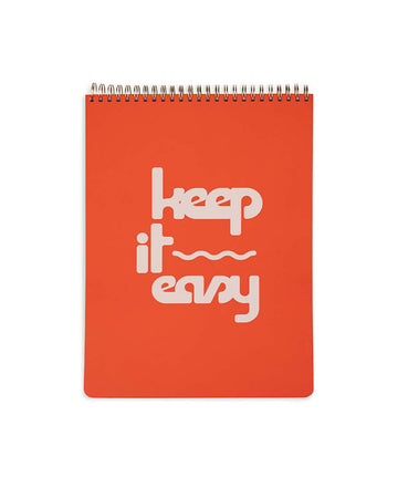 red top spiral notebook with white 'keep it easy' across the front