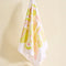 hanging light pink tea towel with yellow and pink breakfast food print