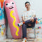 designer with pink inflatable hot dog pool float with mustard front and 'buns' back