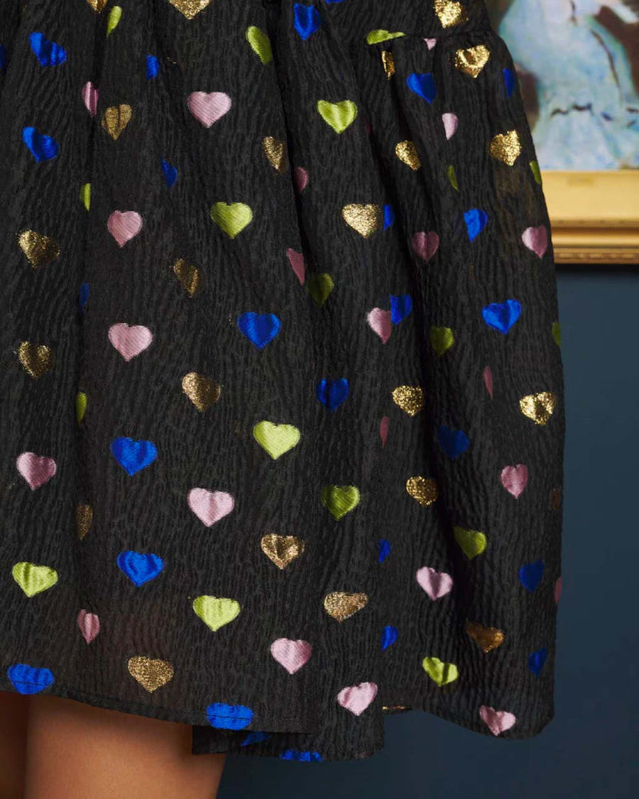 Close up of the bottom of the mini dress with metallic hearts