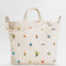 cream horizontal canvas bag with colorful dainty embroidered floral print and zipper closure