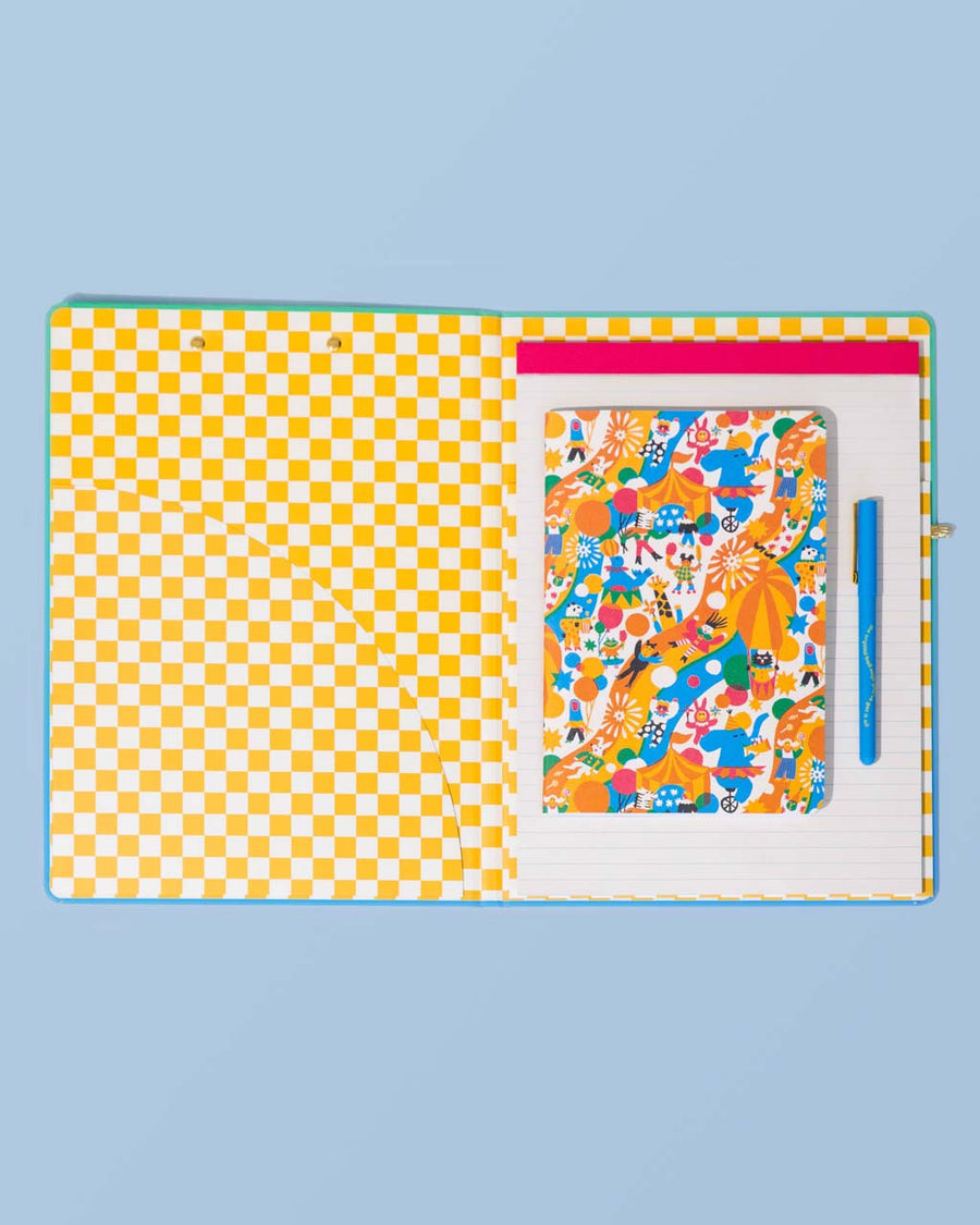 yellow and white checkerboard Interior of the folio, with an extra notebook and pen laying on top.