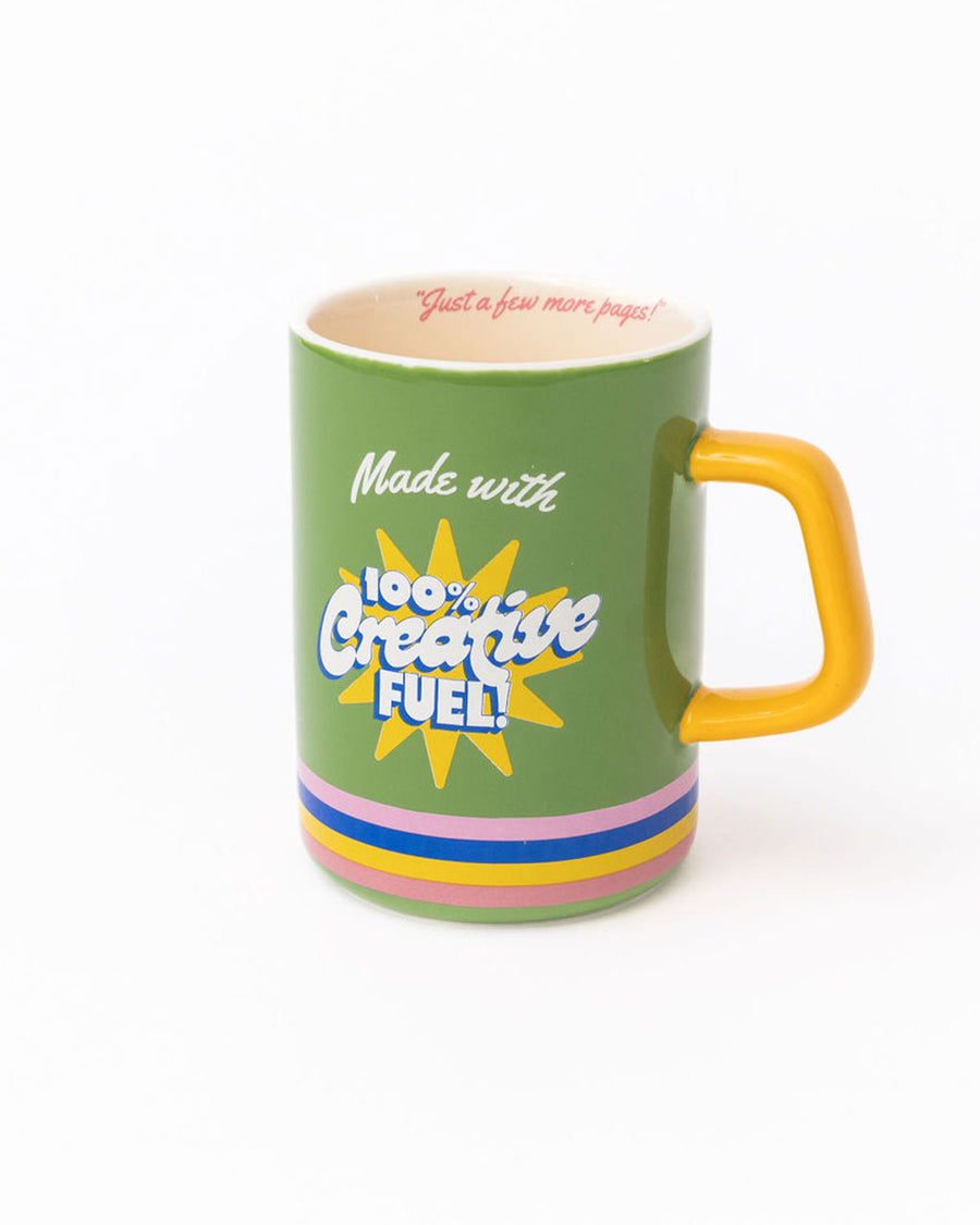 green ceramic mug with yellow handle and 'made with 100% creative fuel!' on the back with 'just a few more pages!' on the inside