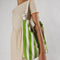 model wearing white and green vertical stripe duck bag