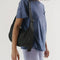 model wearing black medium crescent bag