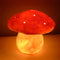 lit handmade and hand painted red and white mushroom lamp