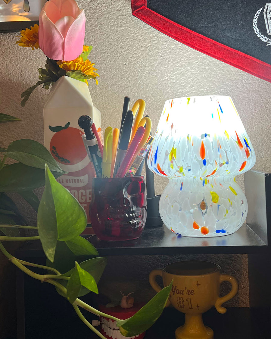 lit white mini mushroom lamp with multicolor streaks