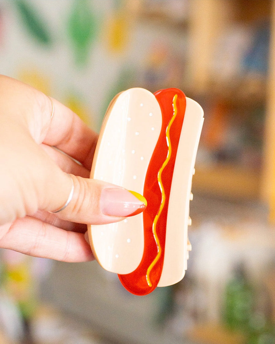 model holding hot dog hair clip with mustard squiggle