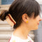 model wearing hot dog hair clip with mustard squiggle