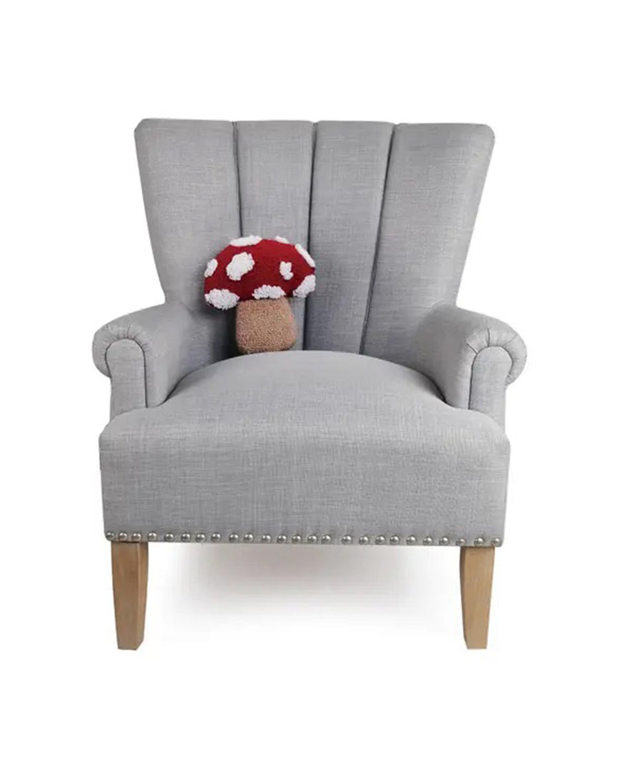 red and white mushroom shaped throw pillow on grey armchair