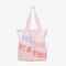 pink canvas tote with "ONE DAY AT A TIME" text graphic