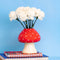 editorial image of mushroom vase with red top and white polka dots and white stem