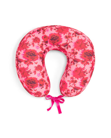 Pink floral motif travel pillow with a grosgrain tie. 