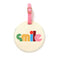 round luggage tag with cream ground, multicolor 'smile' and pink closure
