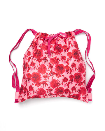 Satin drawstring backpack in a pink floral motif and velvet drawstrings.