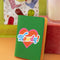 green passport holder with colorful 'howdy' across the front