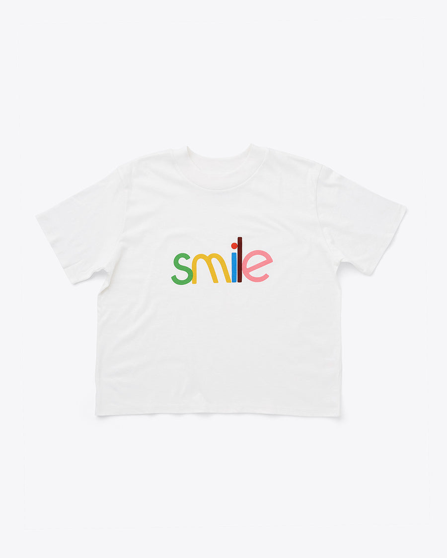 ivory cropped crew neck tee with multi color 'smile' across the front